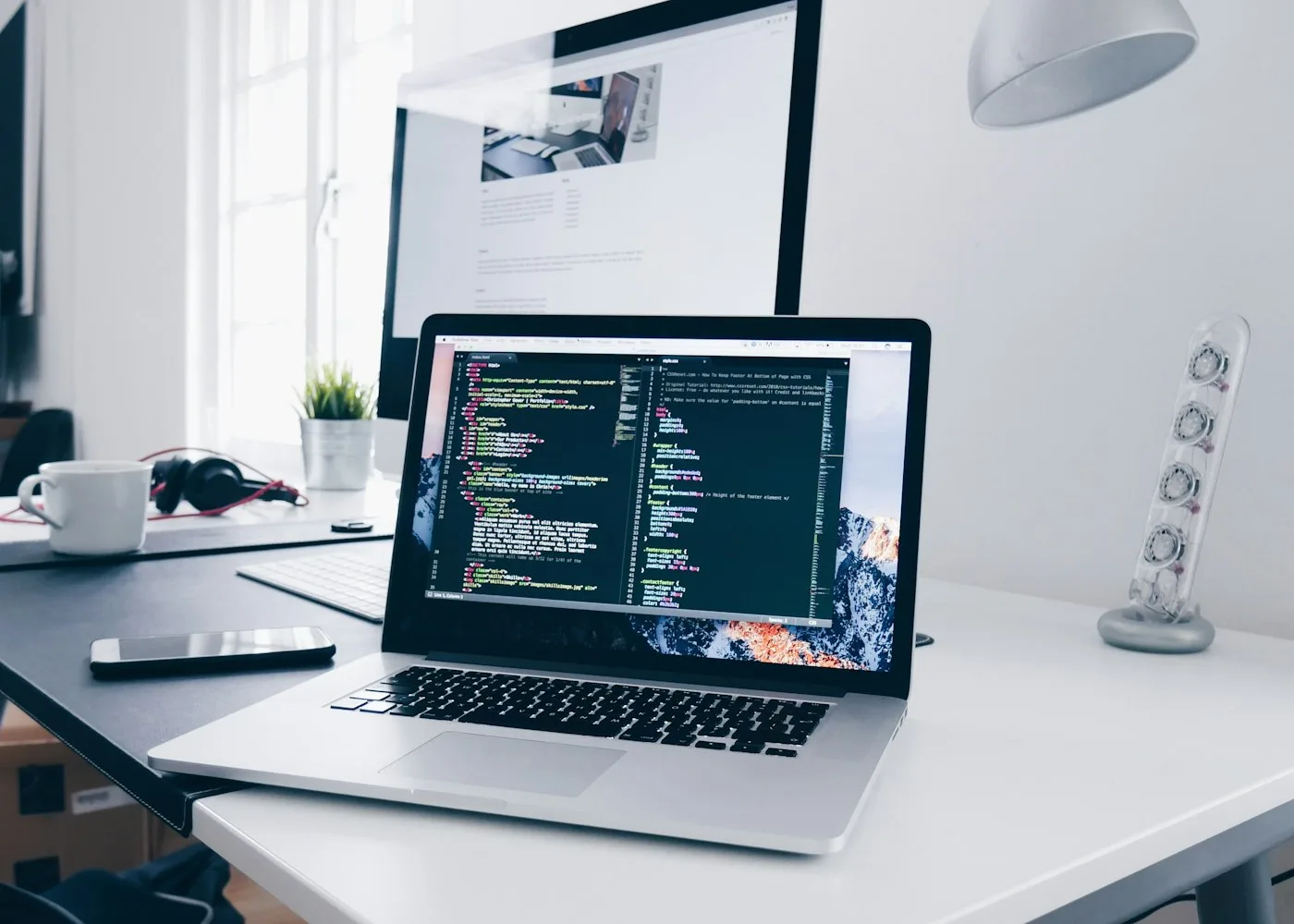 DevOps checking deployment pipelines on dual monitors