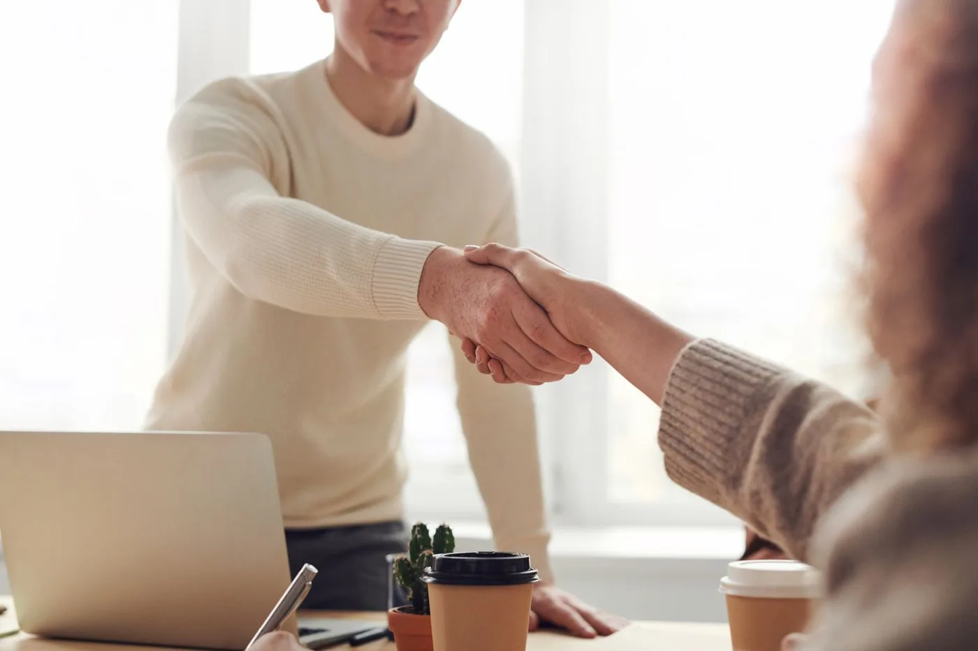Client and Flexus lead shaking hands after aligning on a plan