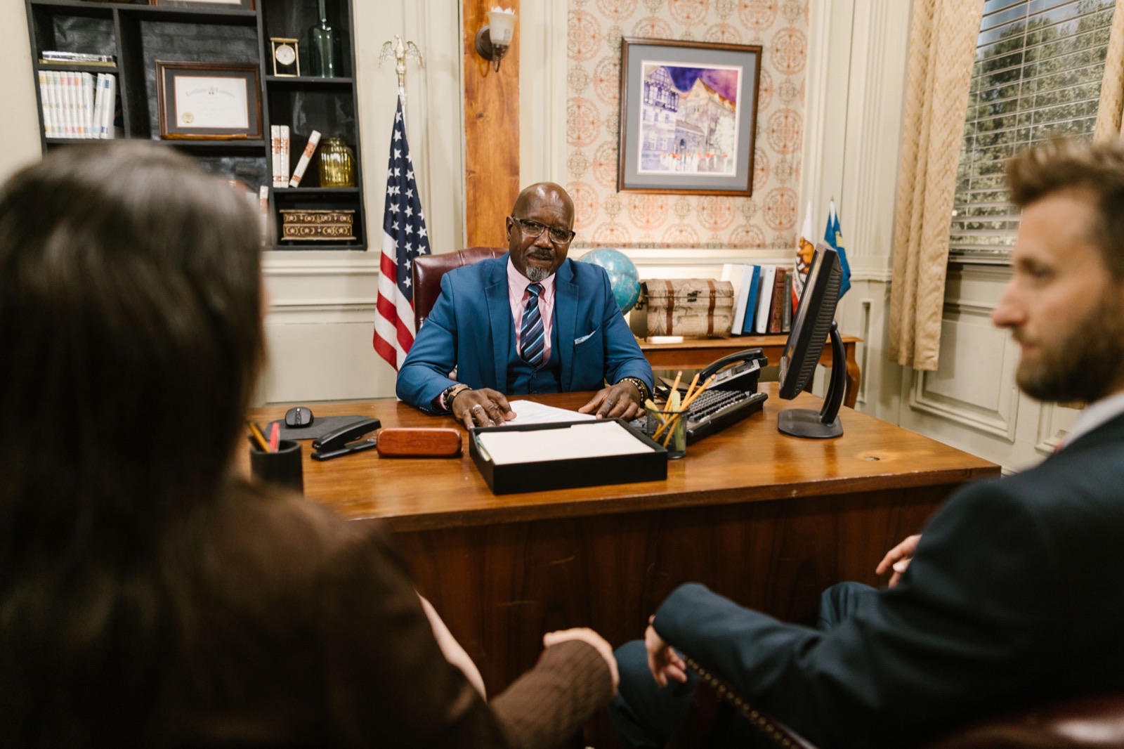 Attorney consulting clients in a law office