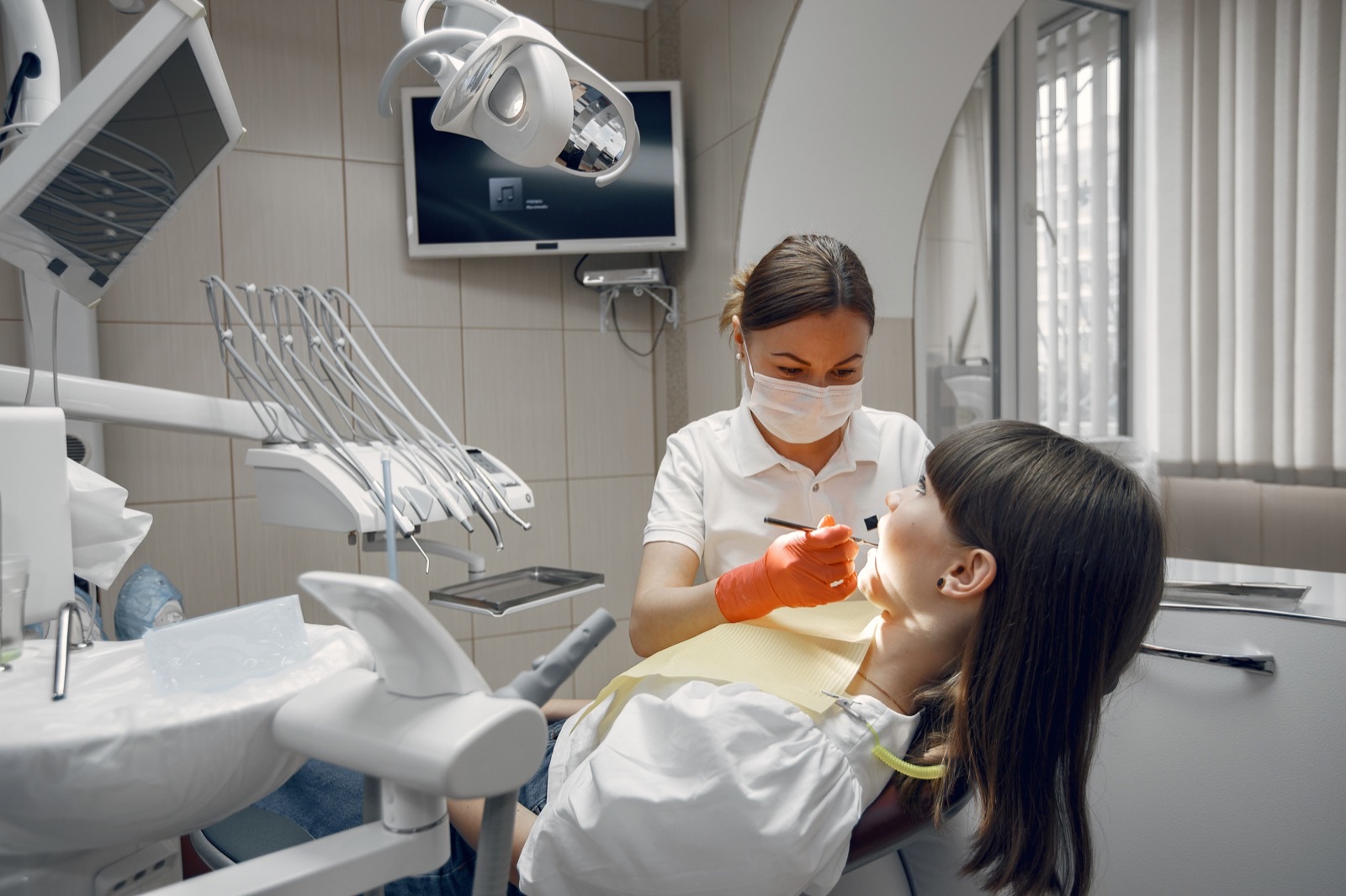 Dentist treating a patient in a modern clinic