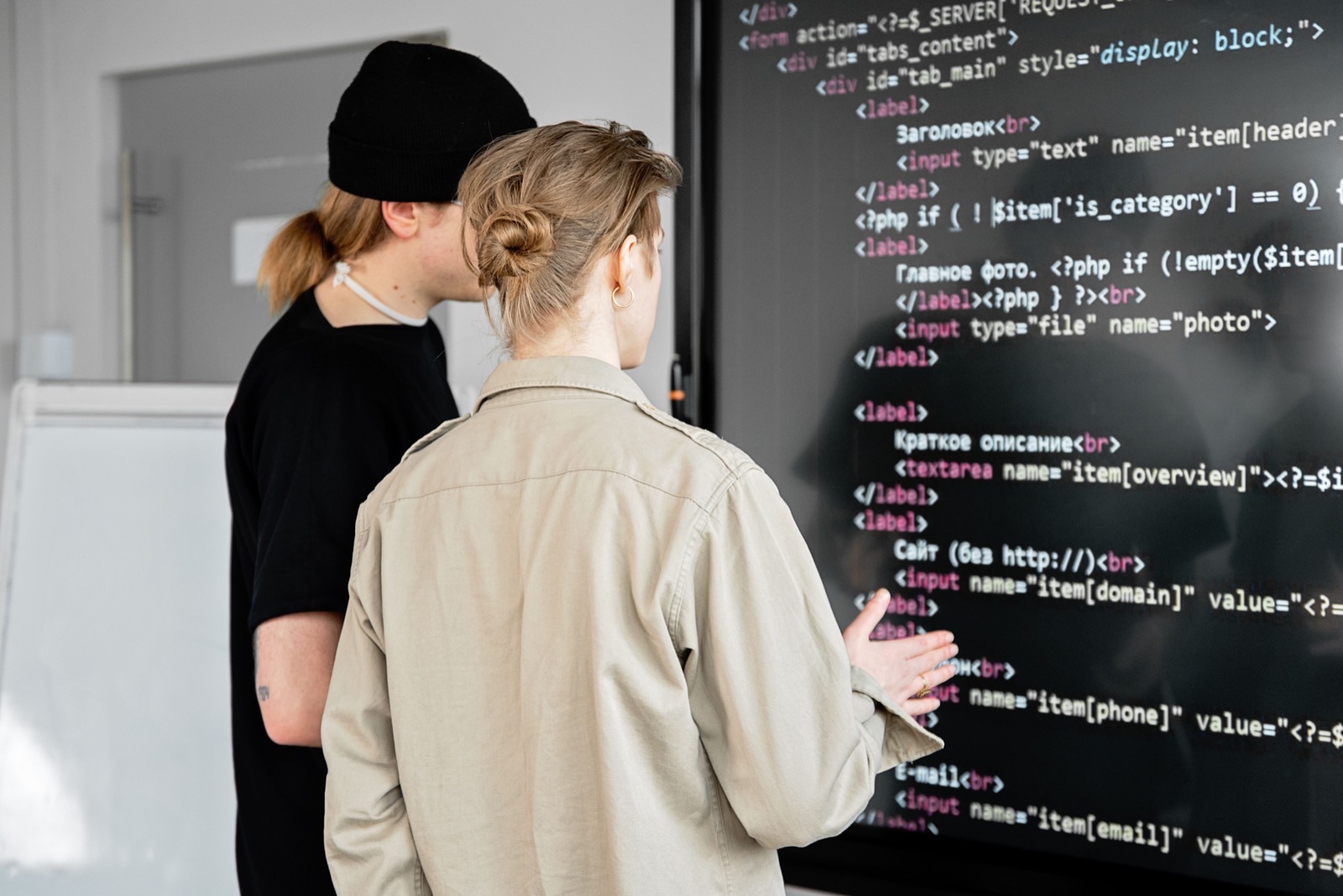 Engineers reviewing tenant-ready software on a large screen