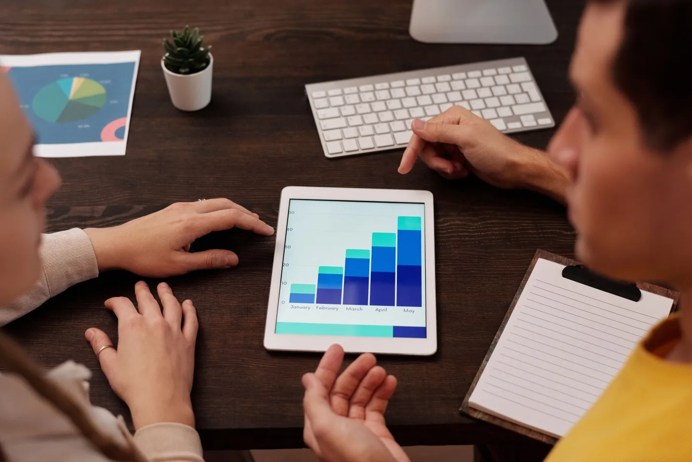 Marketing team reviewing analytics on a tablet