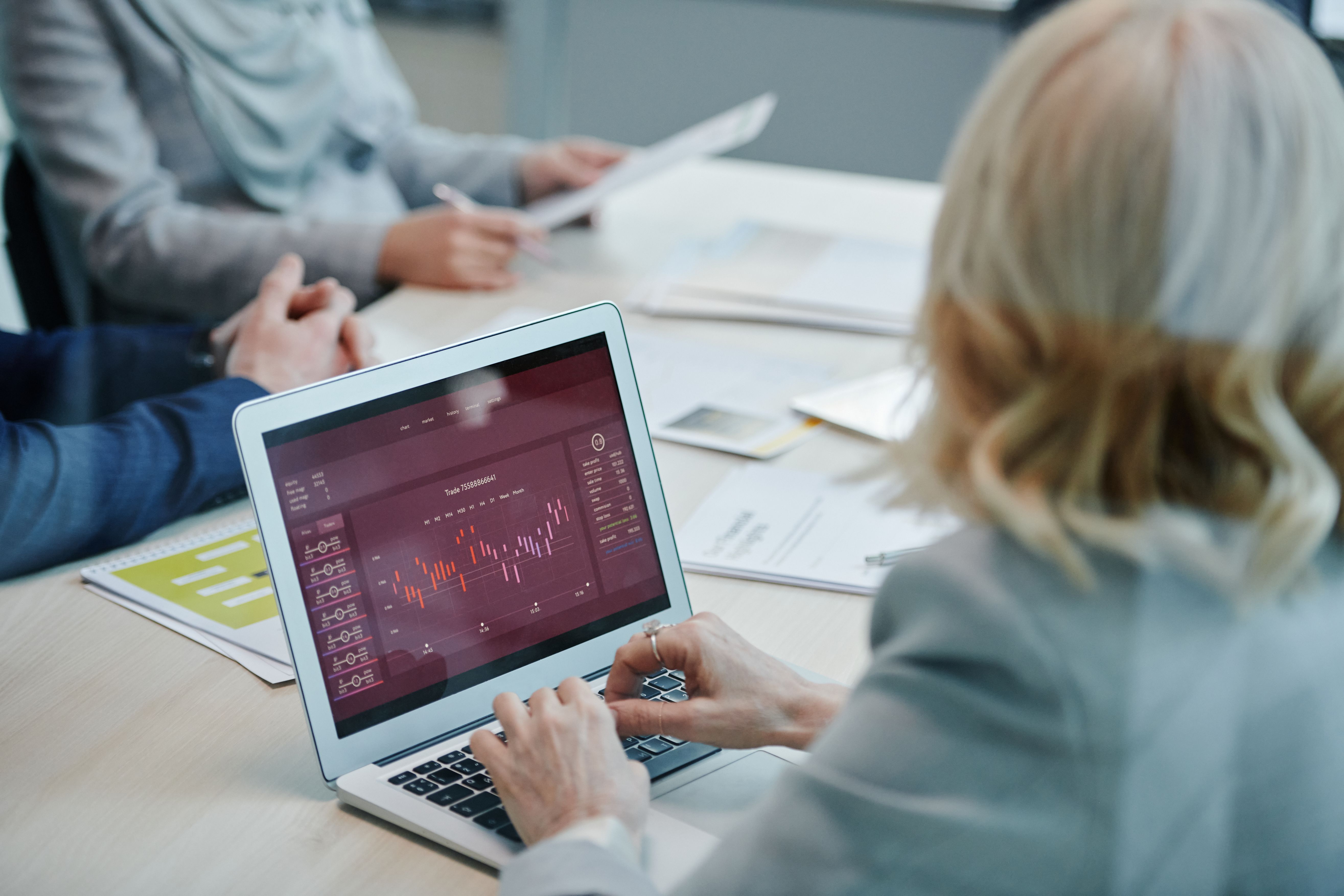 Team analyzing marketing data on a laptop in a meeting