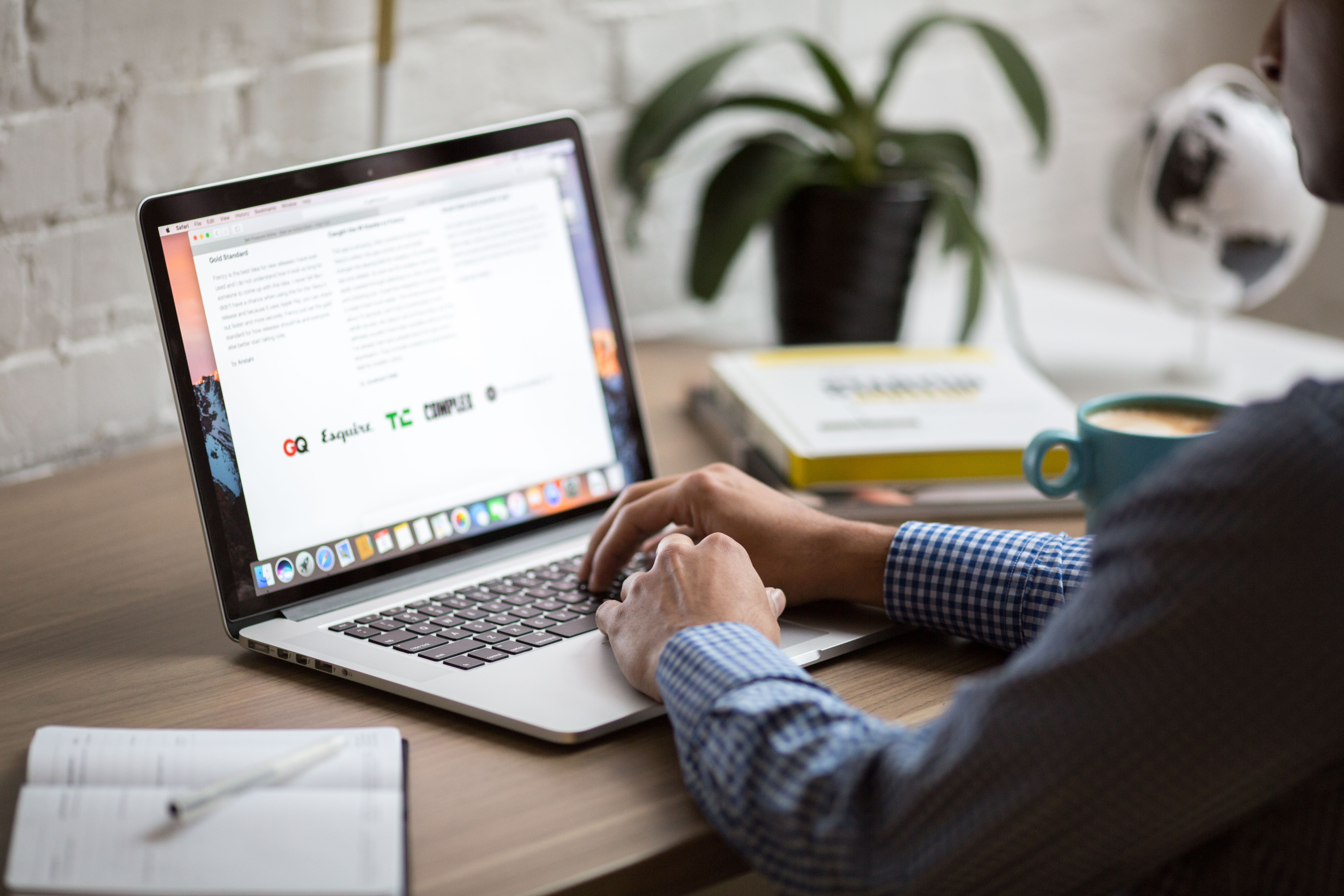 Marketer working on laptop planning email campaigns