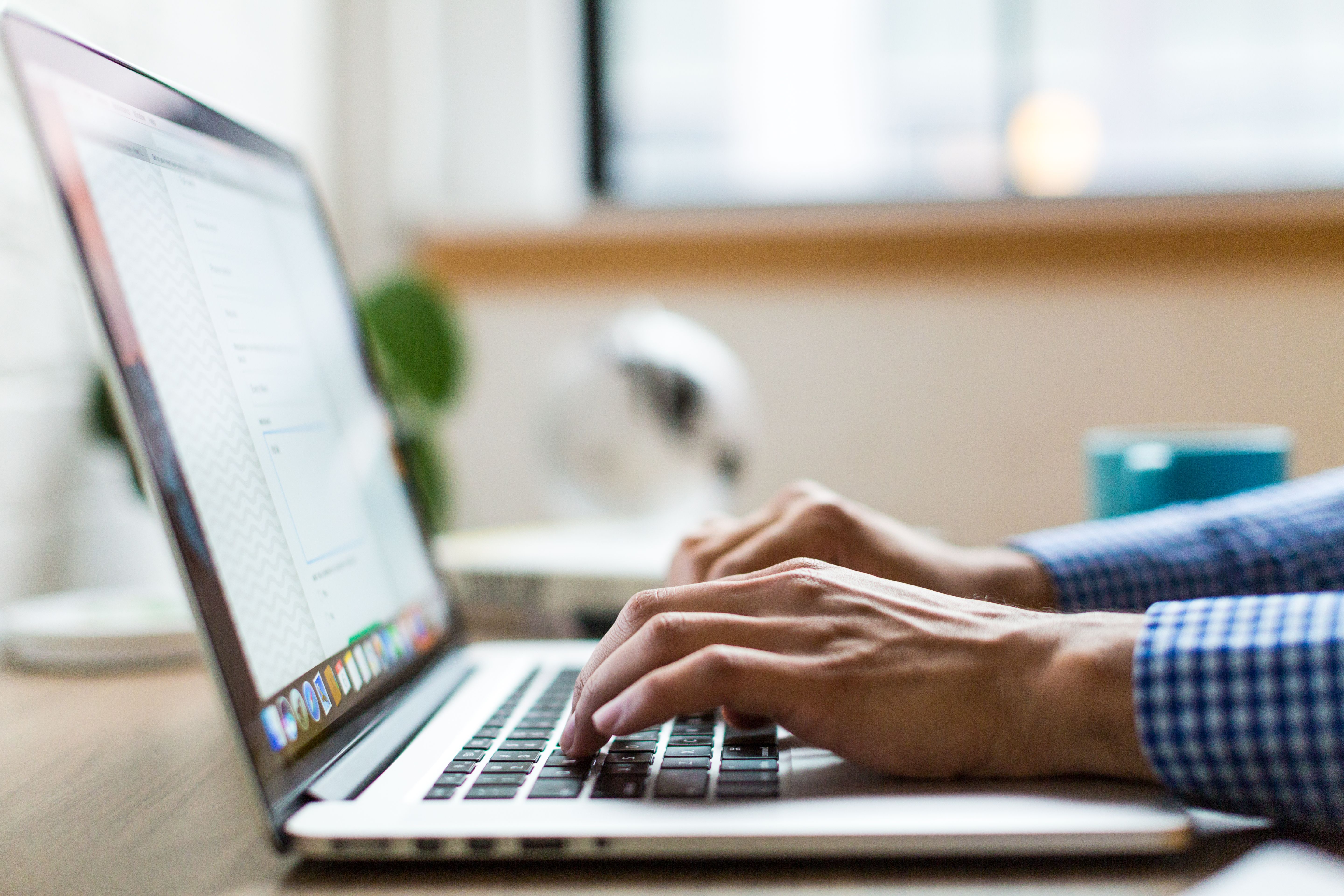 Professional typing email marketing copy on a laptop