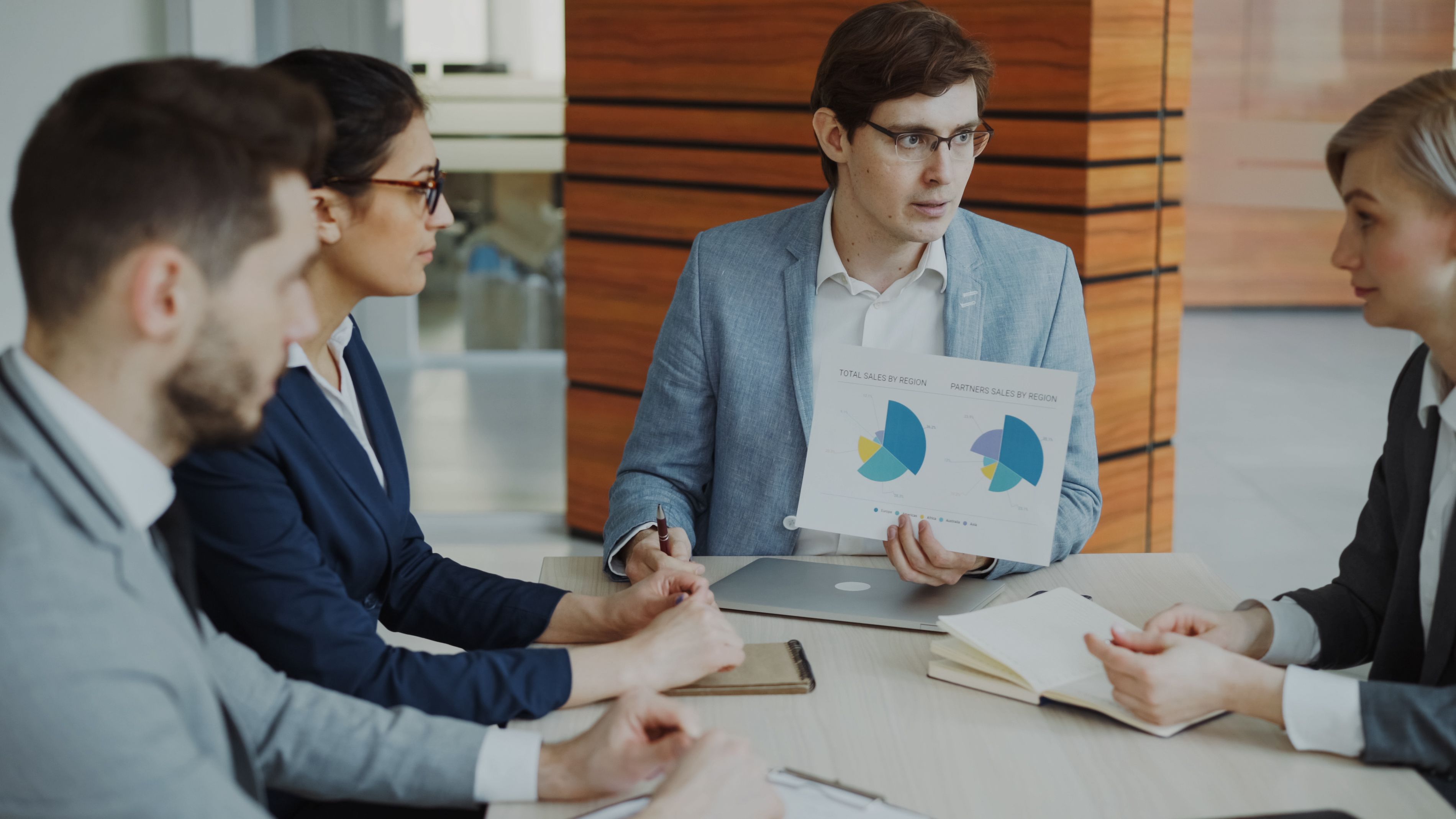 Professionals reviewing lead generation charts in a meeting