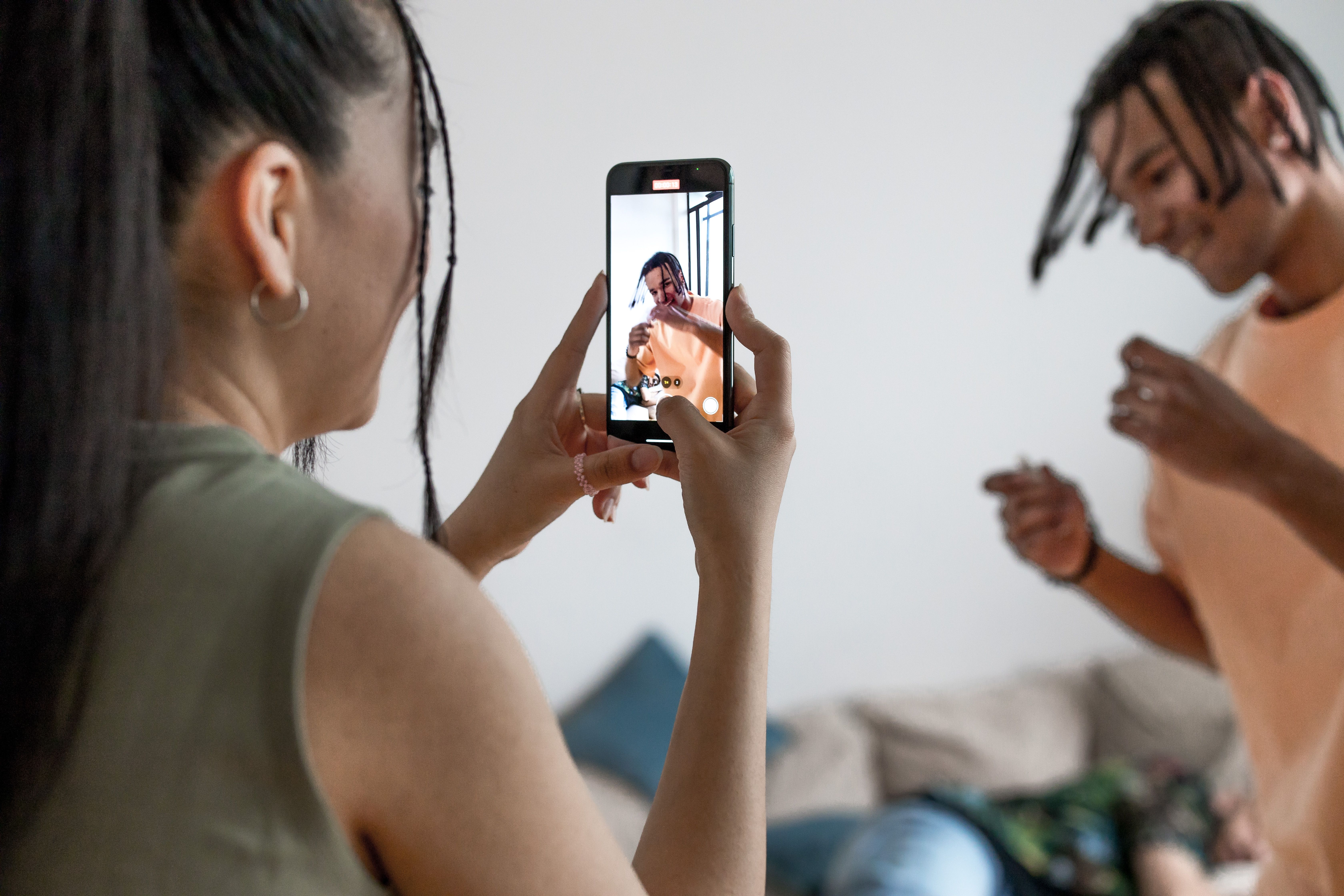 Creator filming social media content with ring light setup