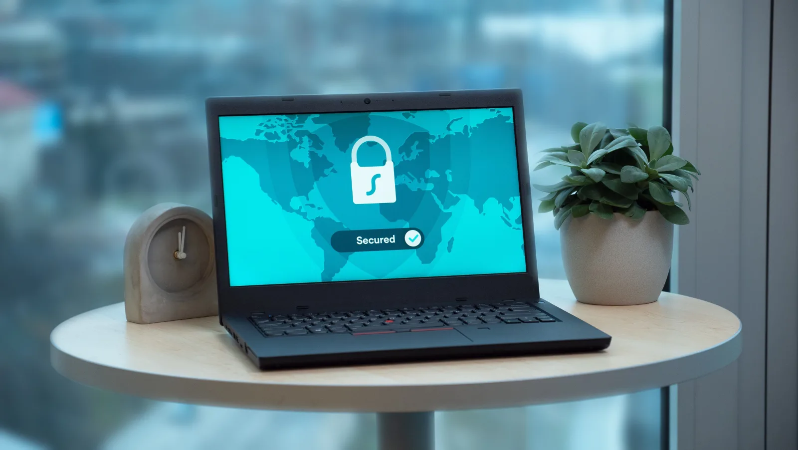 Laptop showing a digital lock icon on a desk — data privacy and security