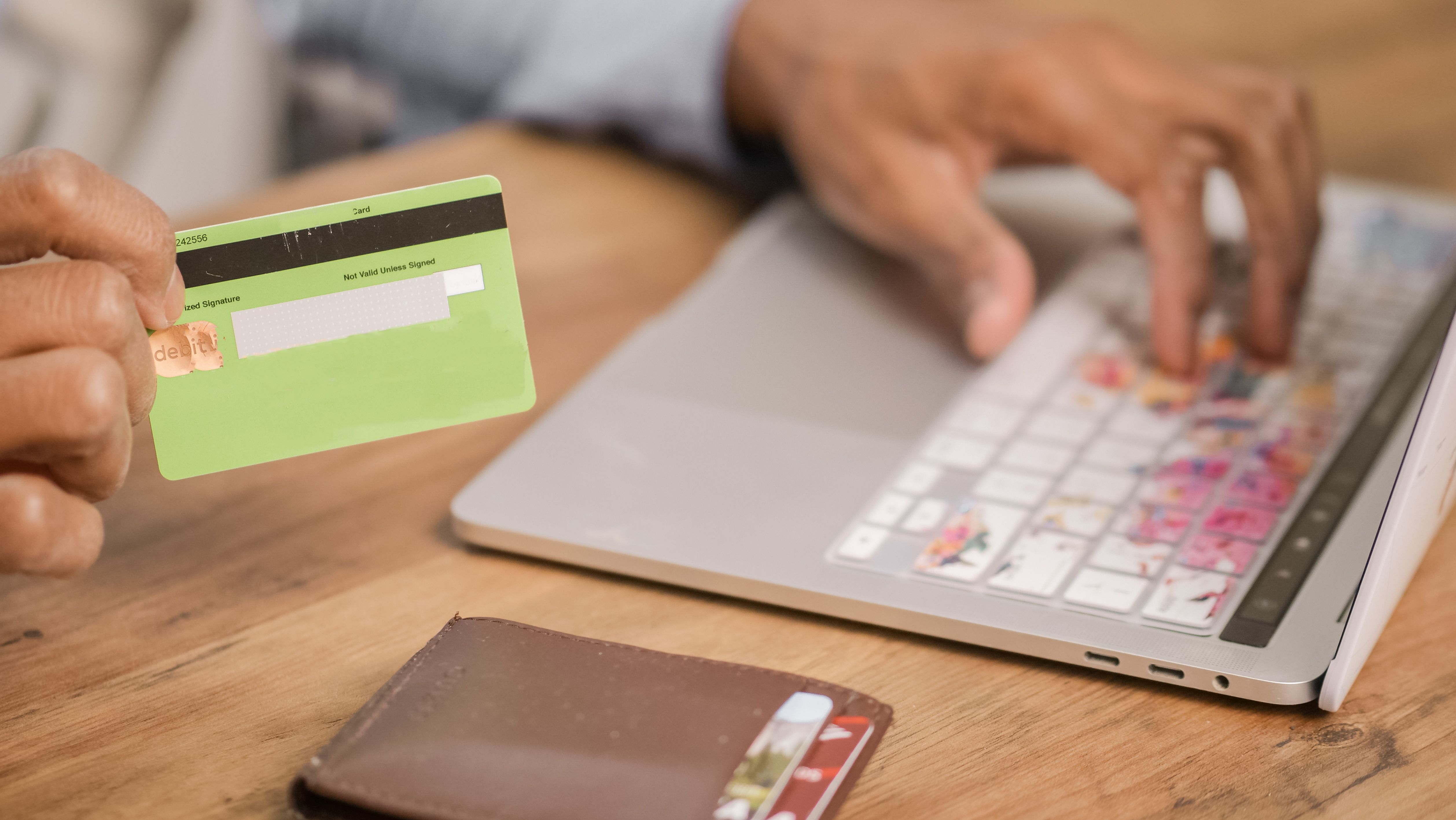 Person checking out online with a credit card and laptop