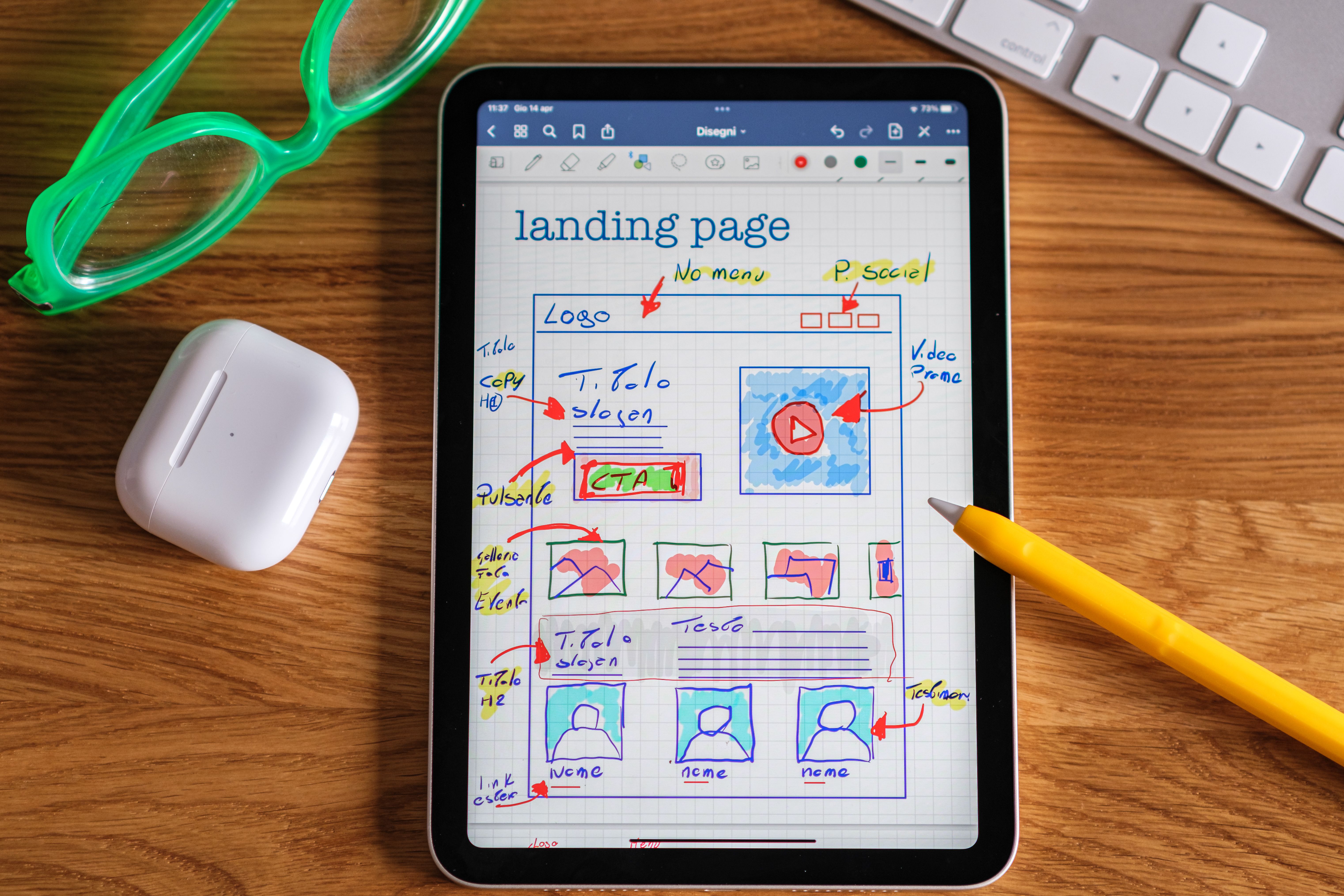 Tablet with a hand-drawn landing page wireframe for web design