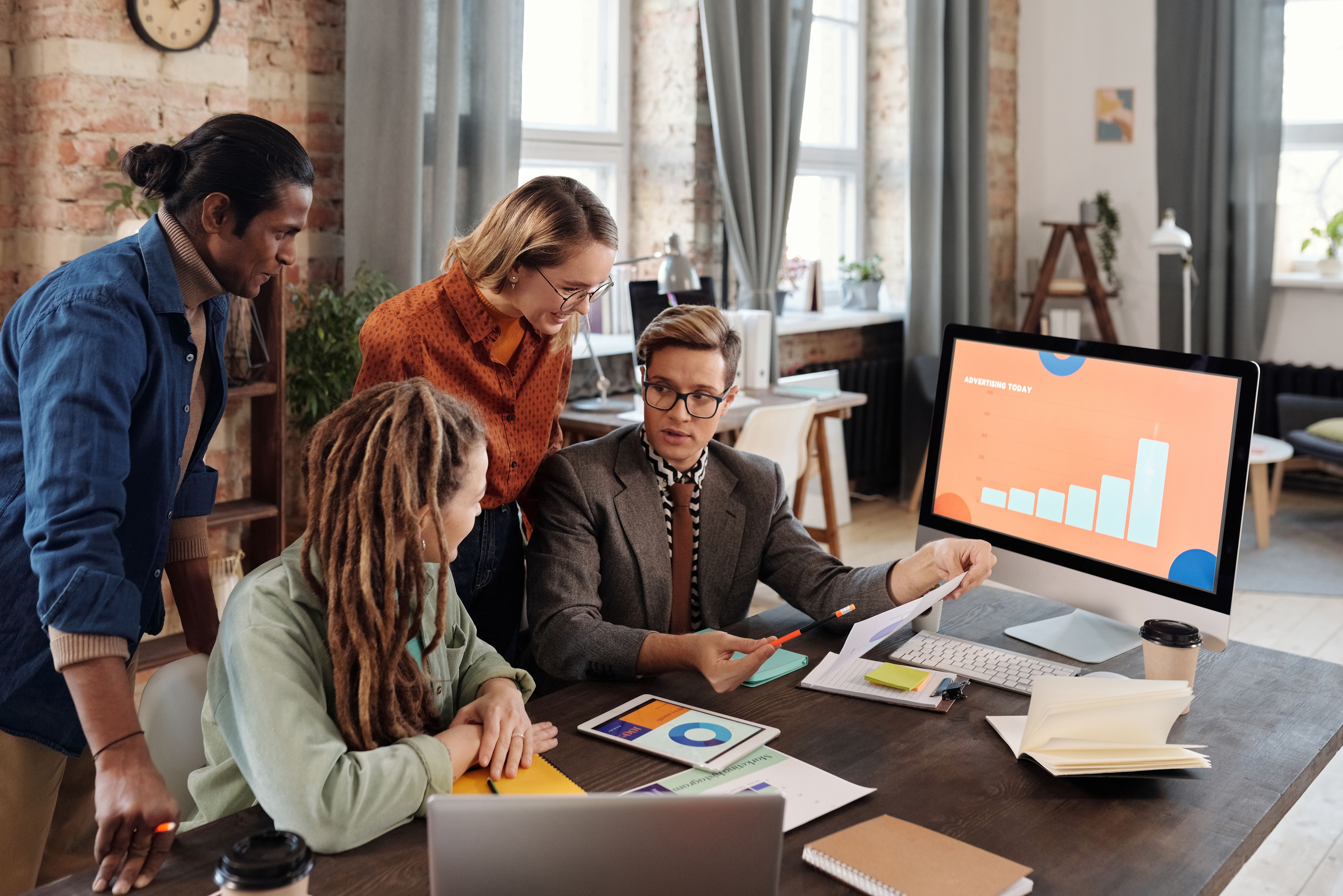 Marketing team reviewing digital campaign plans in a modern office