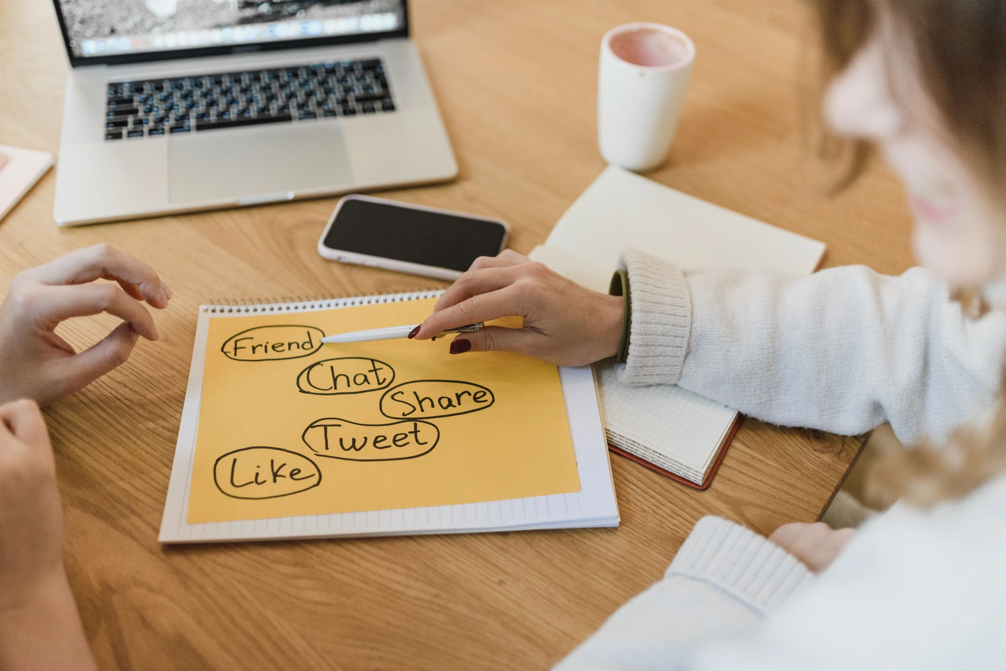 Marketers planning a social and content strategy with a laptop