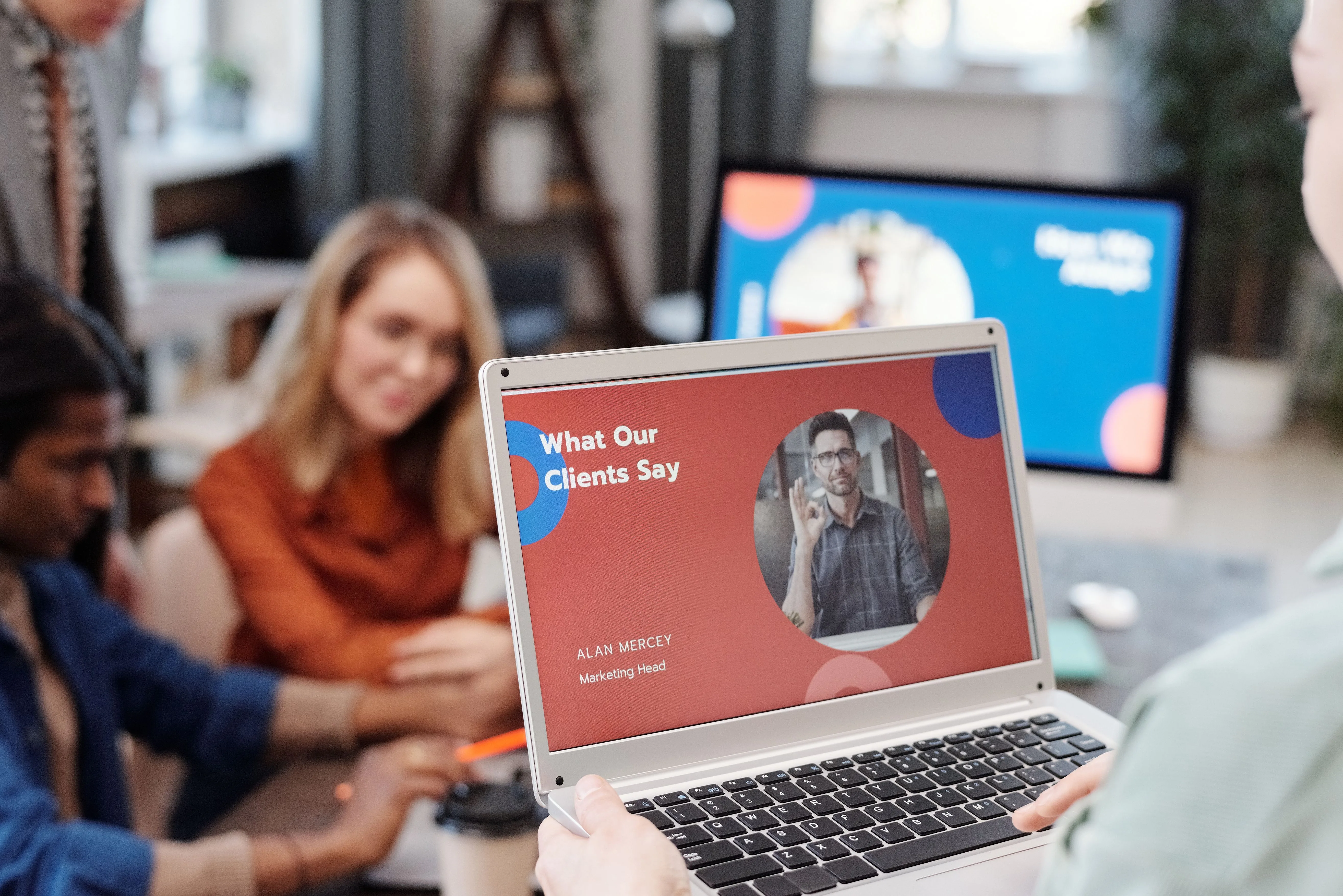 Team reviewing client work together on a laptop