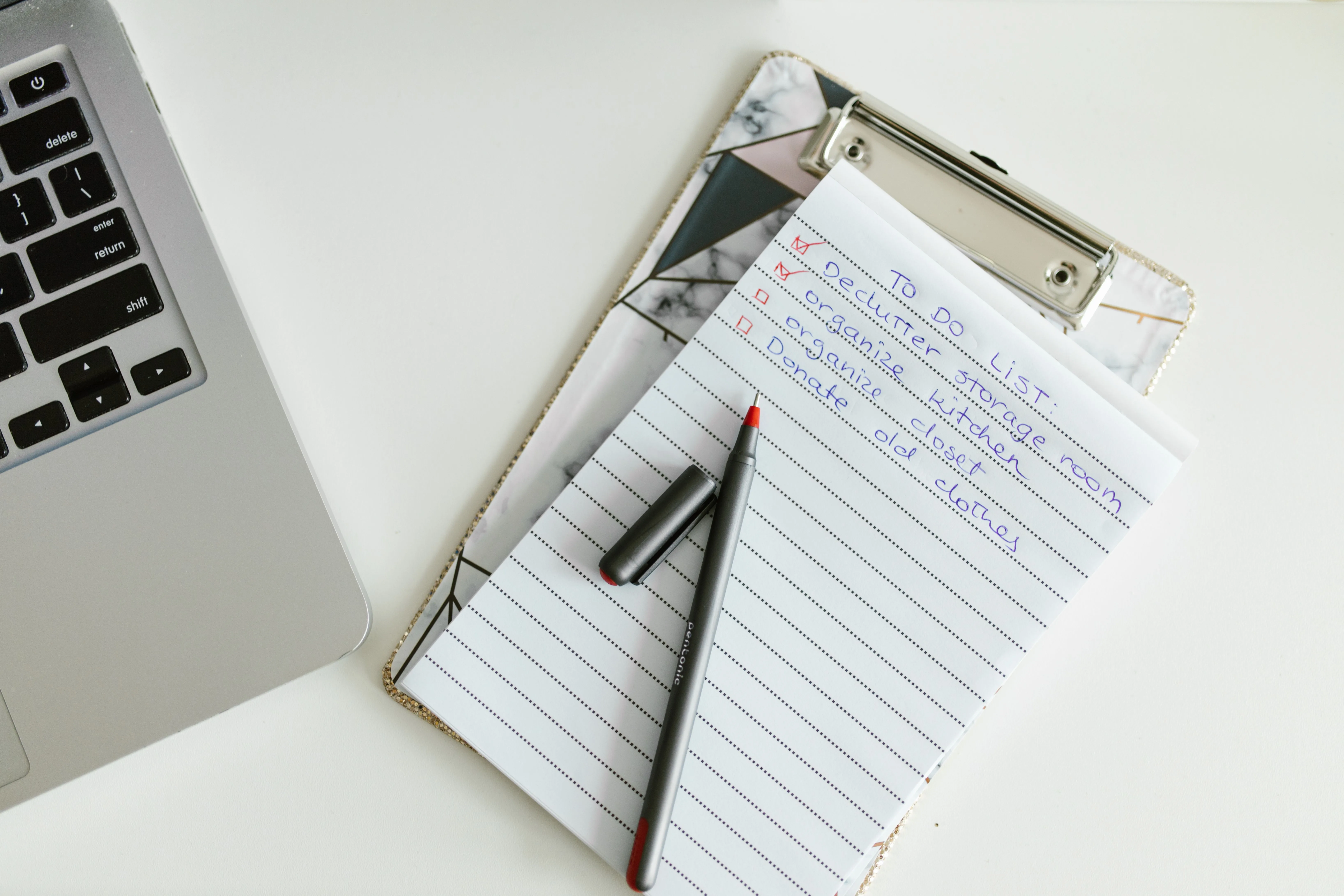 Clipboard checklist beside a laptop for planning digital work